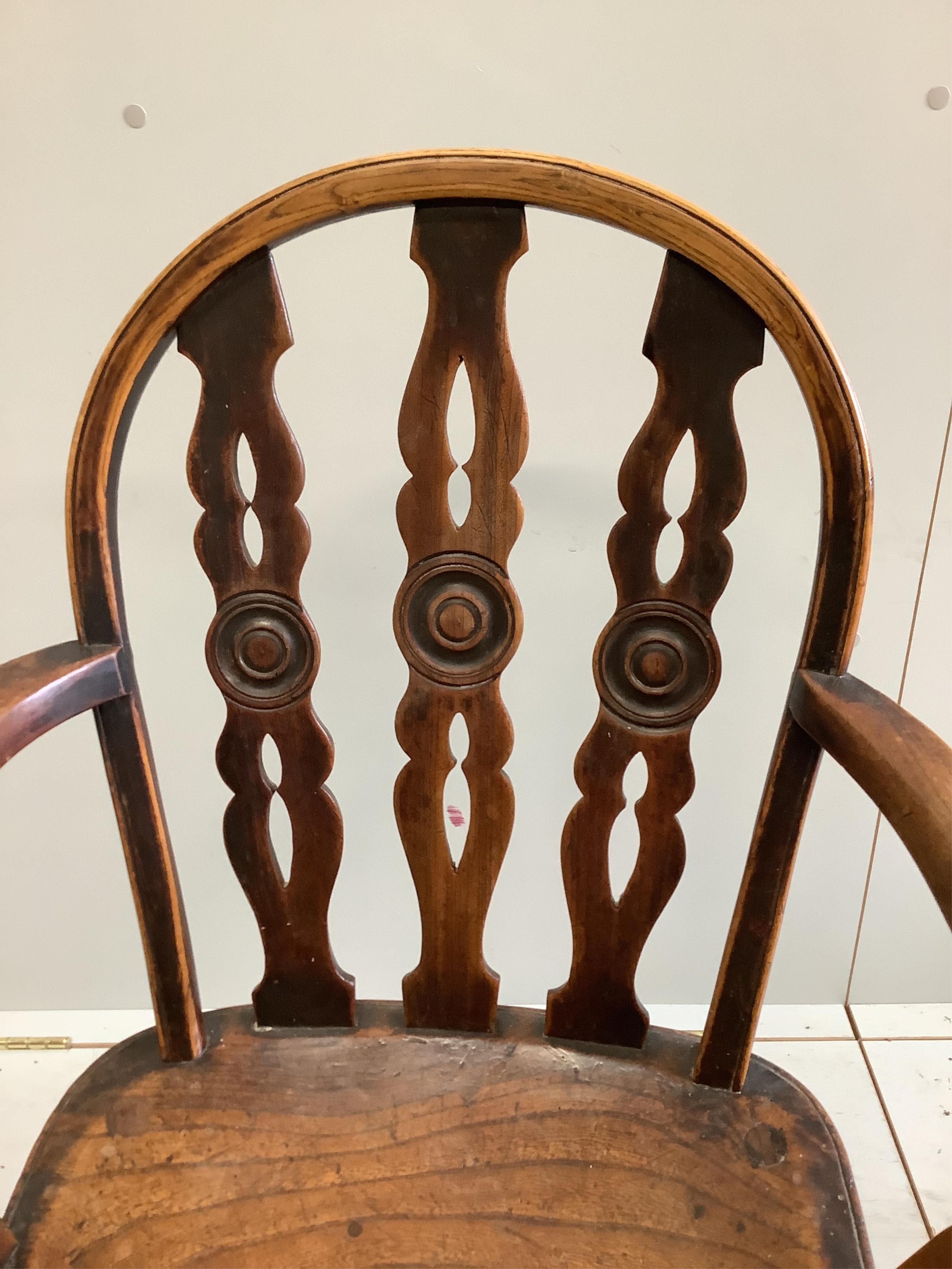 Attributed to Robert Prior, a 19th century Thames Valley elm and beech Windsor elbow chair, with crinoline stretcher, width 52cm, depth 42cm, height 90cm. Condition - fair